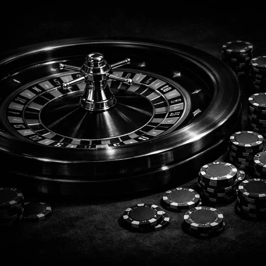 Roulette wheel and scattered chips on a dark table, lit by crisp metallic highlights